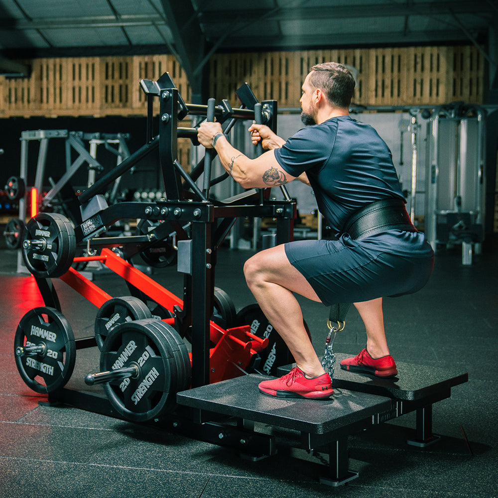 Man squatting on Plate-Loaded Belt Squat