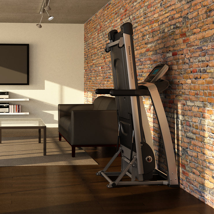 F3 treadmill folded against brick wall, home loft