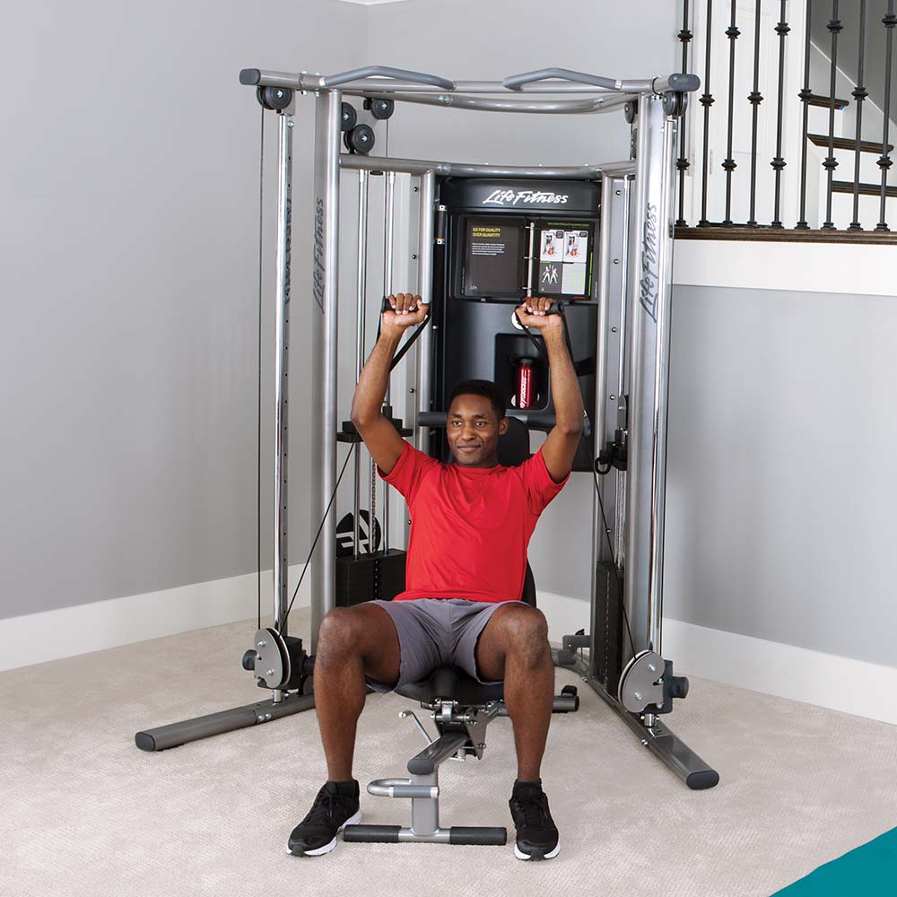 G7 Home Gym With Optional Bench, man doing cable exercises while sitting on bench, at home