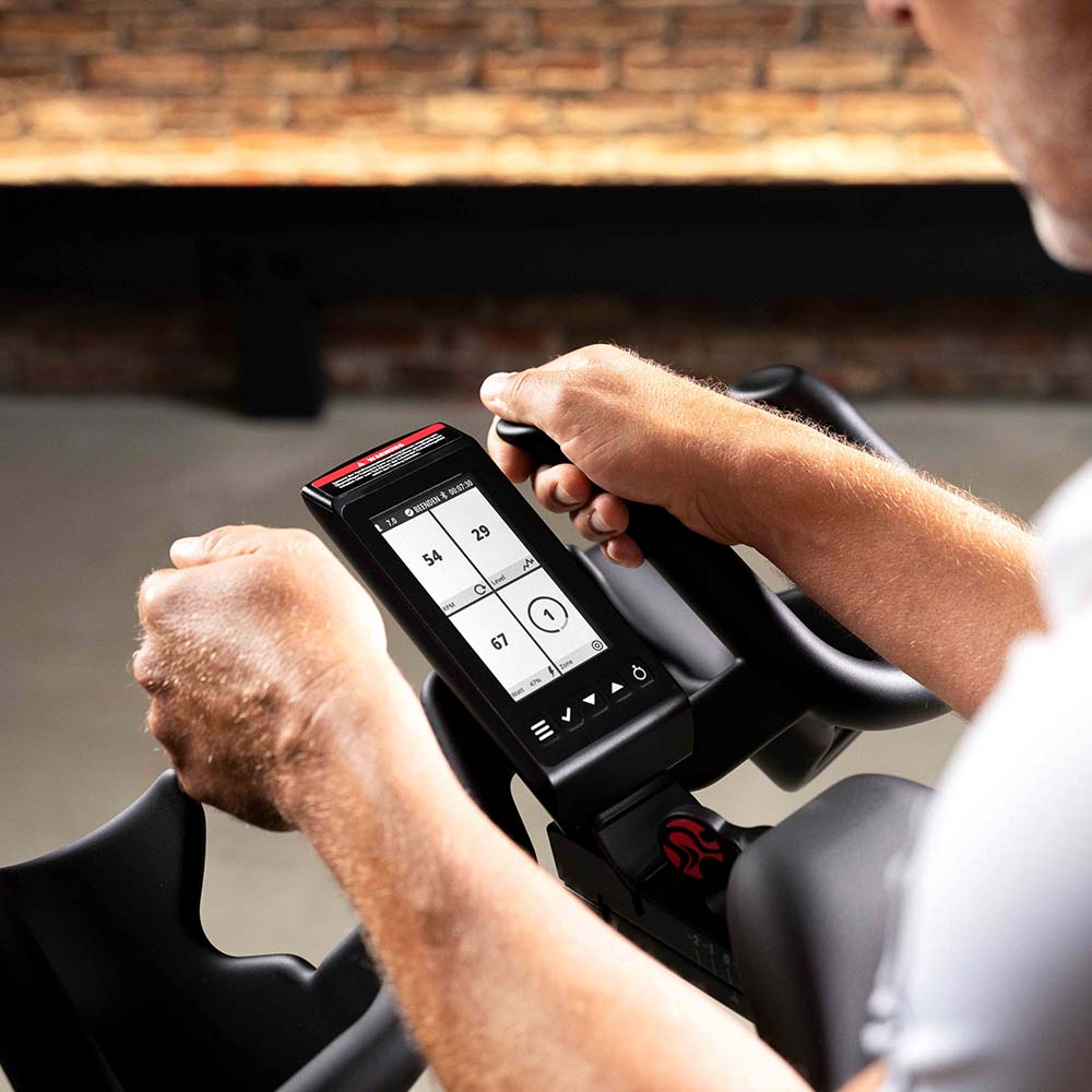 TFT LED console displaying workout metrics while man is riding IC7