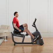 Male pedaling on LIfe Fitness RS3 Recumbent LifeCycle bike, side profile
