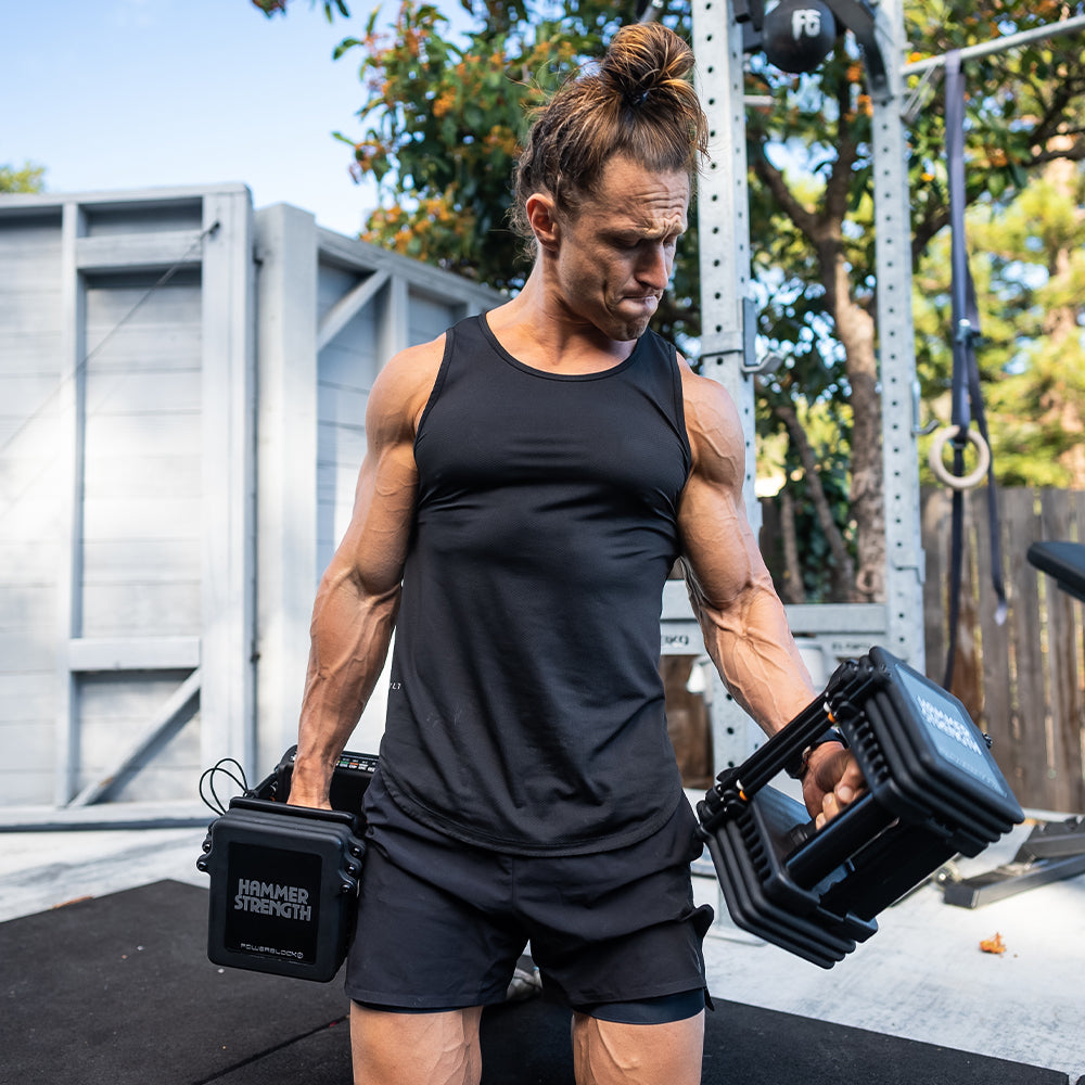 Marcus Filly exercising with PRO 100 Adjustable Dumbbells