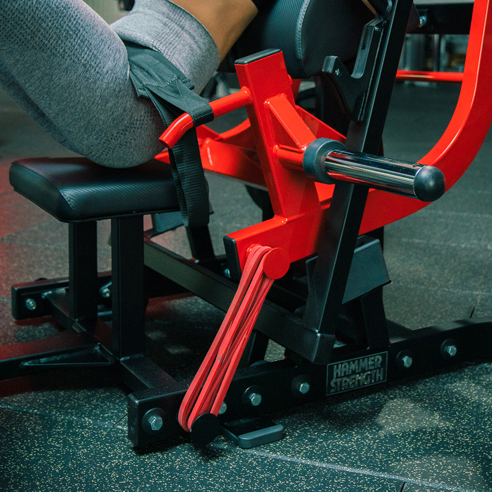 Exerciser using machine with red mini bands