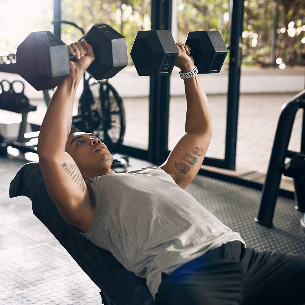 Man pressing with hex dumbbell