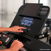 Female controlling Track Connect console on Life Fitness Run CX treadmill