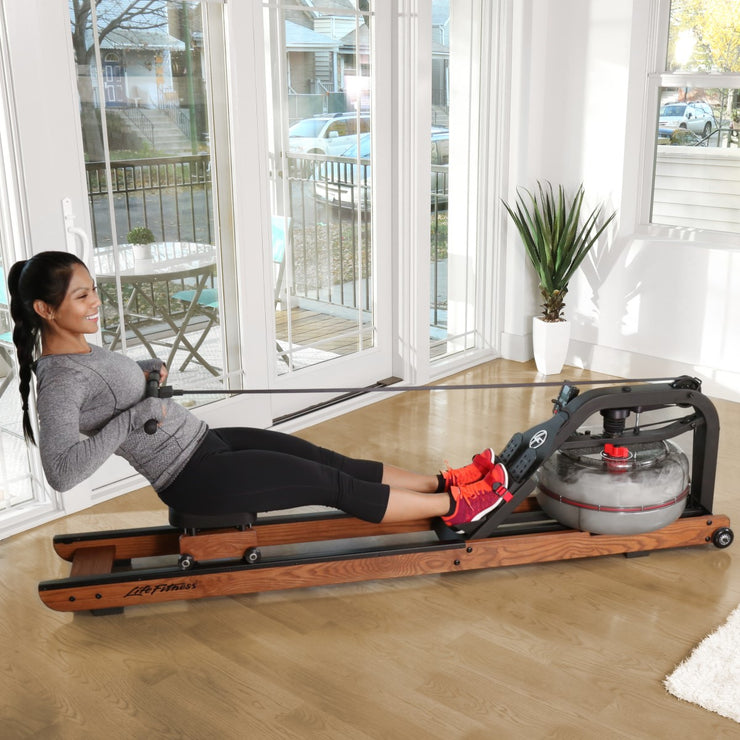 Female rowing at home on Life Fitness Row HX rower